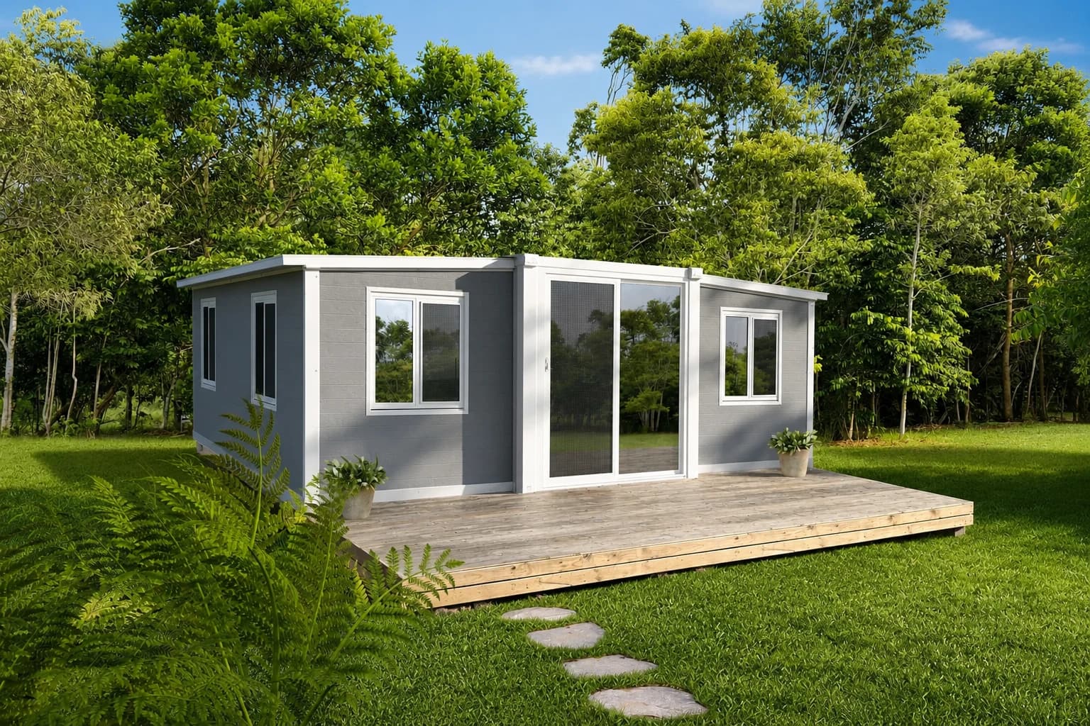 The Aspect — a light grey expandable home opened onto a timber deck in a leafy garden